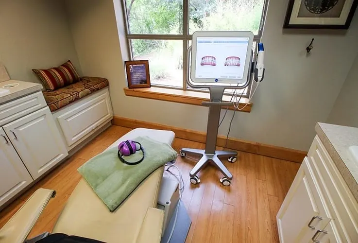 A treatment room at Grand Dental Studio with a comfort blanket on the chair.