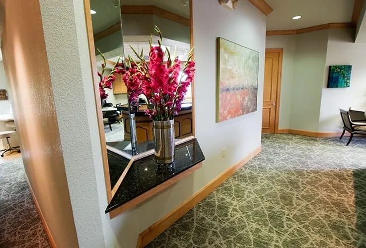Fresh flowers and artwork in the hallway past reception.